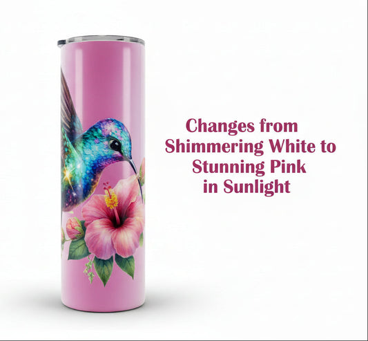 Pink tumbler with a colorful hummingbird and flower design on a white background