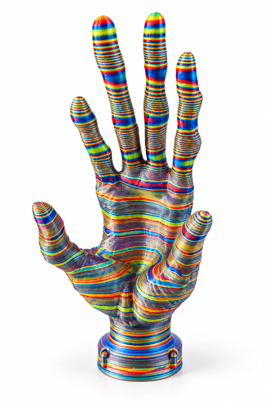A 3D-printed articulated hand sculpture with a multicolor striped pattern, displayed on a wooden table.