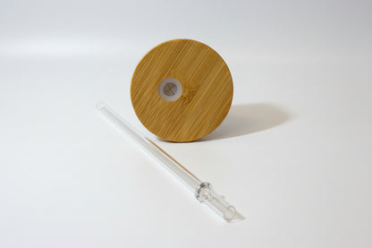 Wooden lid with a clear straw on a white background