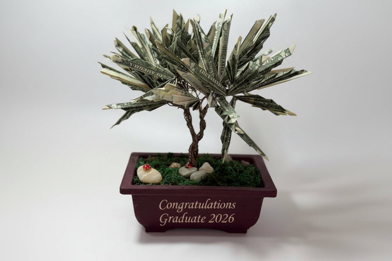 Bonsai tree made from dollar bills in a pot on a white background