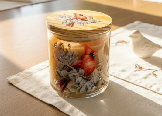 Decorative jar with a wooden lid featuring cardinal birds and floral designs on a white background.