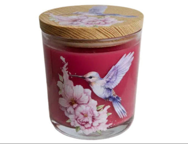Decorative candle jar with a lid featuring a design of a hummingbird and flowers on a gray background.
