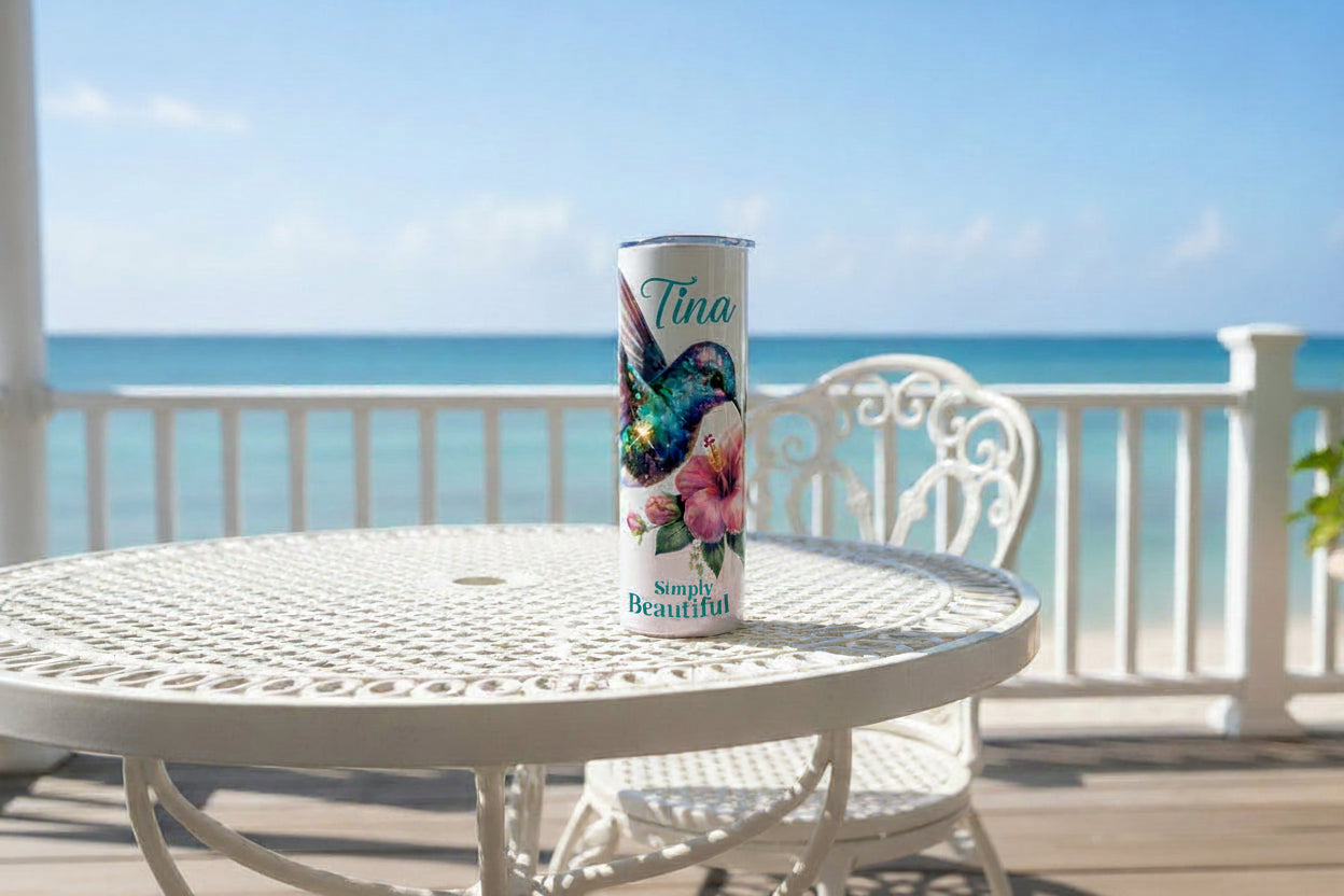 Tumbler with a colorful bird and floral design on a white background