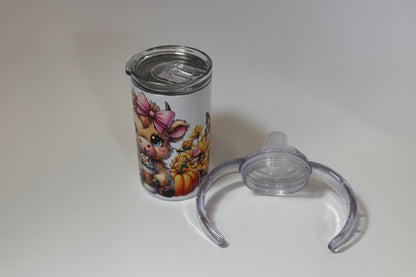Tumbler with animal design and clear lid on a white background